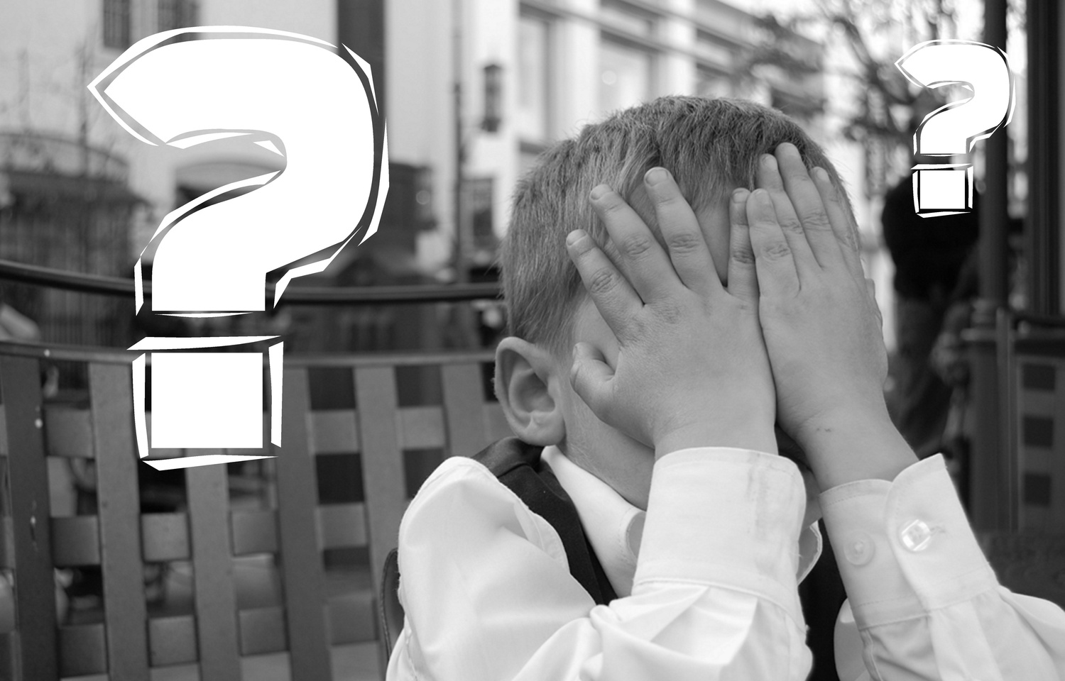 Kid Covering his Eyes Next to a Question Mark